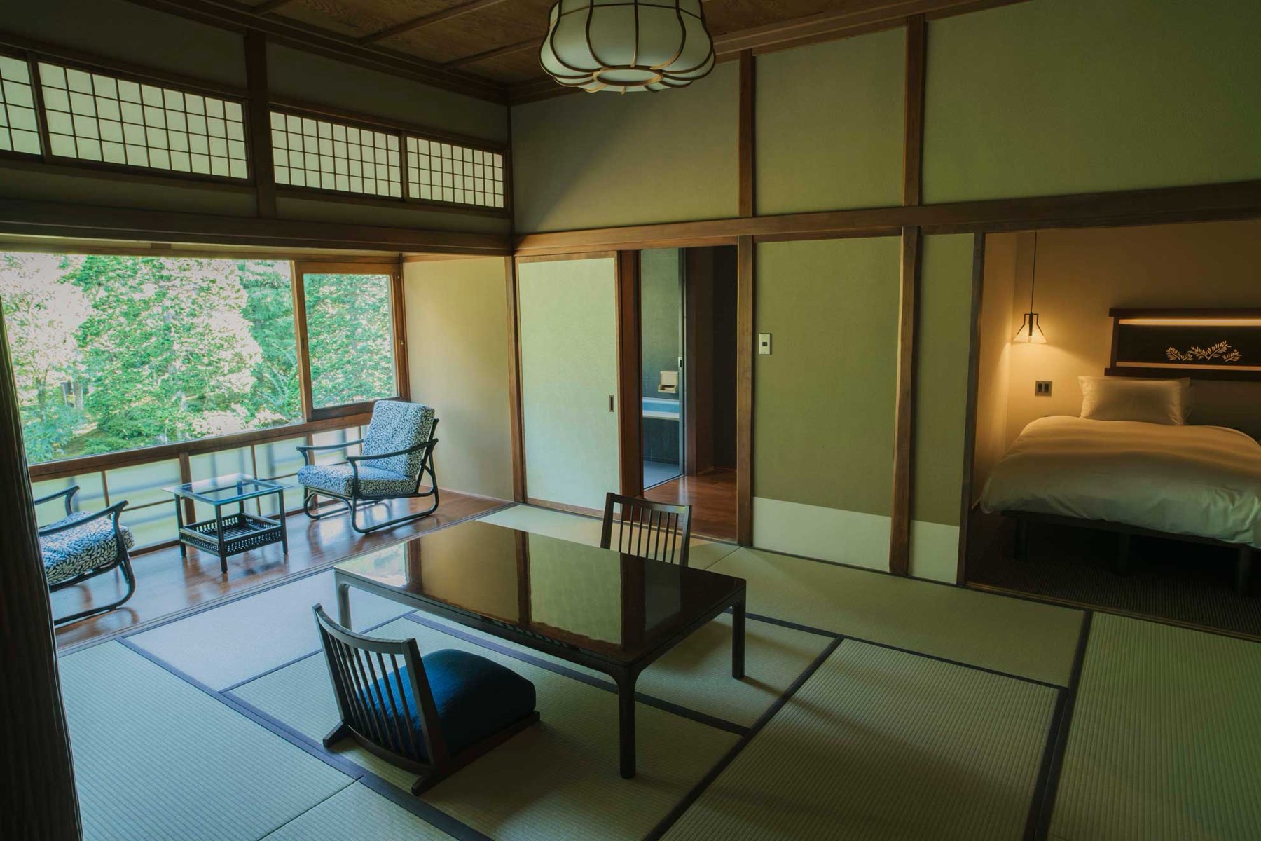 The Matsukaze room — tatami, low table, bed alcove, veranda onto the garden